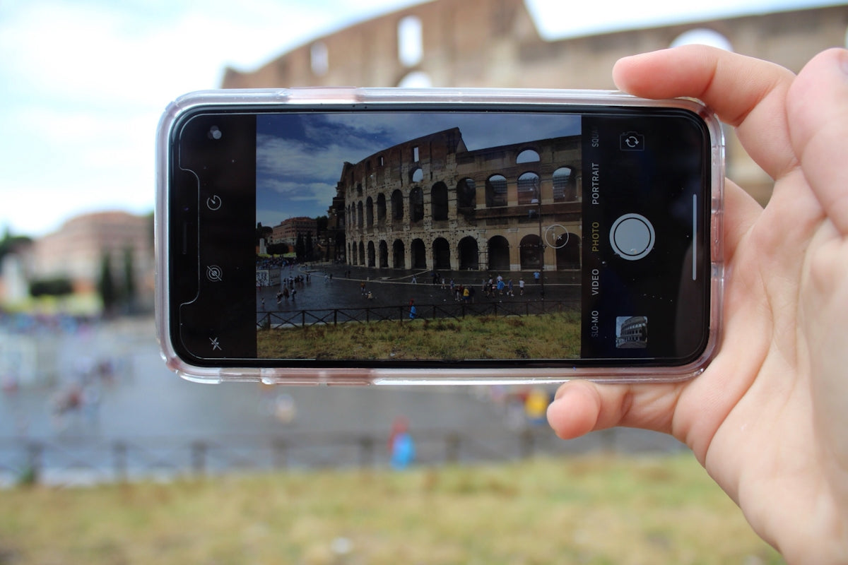 person holding black smartphone taking photo